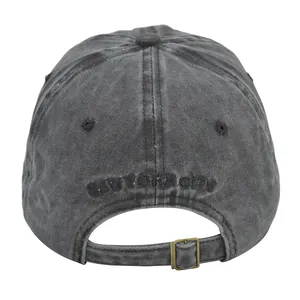 Detail of adjustable metal buckle and New York City embroidery on washed grey baseball cap