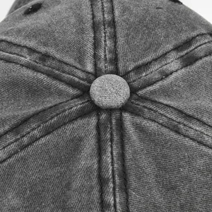 Vue macro d'une casquette rétro grise délavée montrant le bouton et les coutures
