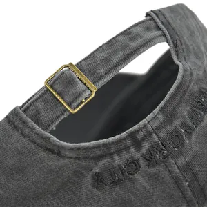 Detail of adjustable metal buckle and New York City embroidery on grey baseball cap