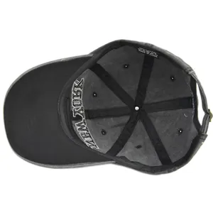 Internal view of dark cotton baseball cap showing 100% cotton label and quality stitching