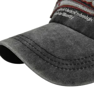 Gros plan d'une casquette en coton noir délavé avec broderie blanche et coutures denses