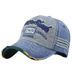 Detailed macro of vintage washed denim baseball cap with 1969 embroidery and distressed brim