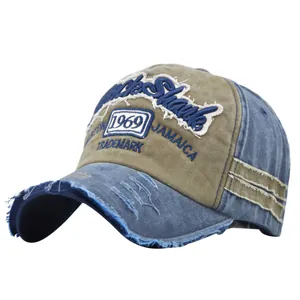 Detailed macro view of vintage distressed 1969 embroidery on khaki and blue baseball cap