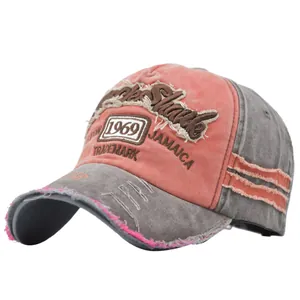 Detail of vintage 1969 Jamaica patch embroidery on washed pink and grey baseball cap