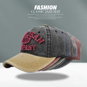Detailed close-up of embroidered vintage baseball caps in various washed colors