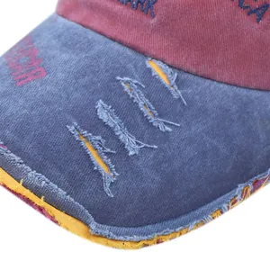 Detail of distressed brim with America embroidery on vintage washed cotton baseball cap