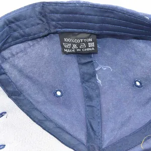 Detail view of cotton baseball cap interior featuring material tag and stitching