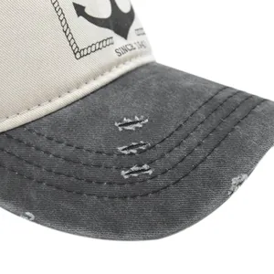 Detail of distressed baseball cap with anchor print and vintage worn edge on the brim