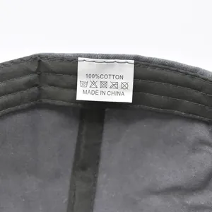 Detail view of the 100% cotton wash care label inside a vintage anchor baseball cap
