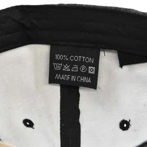 Detail view of the 100% cotton washing label inside the black vintage baseball cap