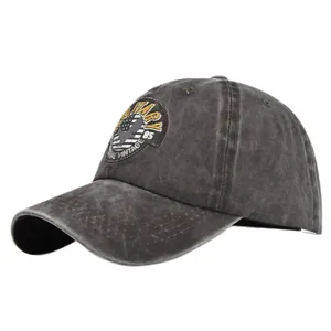 Detailed close-up of distressed charcoal baseball cap with vintage military embroidery