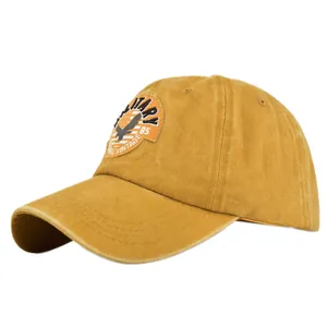 Detail of military style embroidery and washed cotton texture on mustard baseball cap