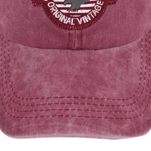 Detail of vintage red military baseball cap featuring an eagle embroidery and stitching