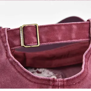 Detail of the adjustable back strap with vintage metal buckle on wine red baseball cap