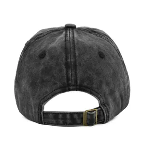 Close-up of vintage washed black cotton baseball cap with adjustable bronze metal buckle