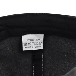 Detailed close-up of 100% cotton material and wash label inside the vintage baseball cap