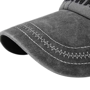 Close-up of star embroidery and double white stitching on washed cotton baseball cap brim