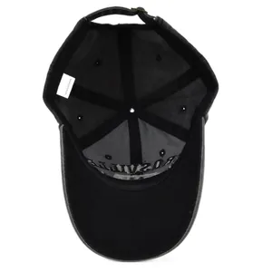 Detailed interior of vintage black cotton baseball cap showing seams and metal buckle