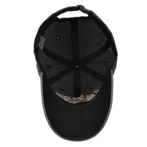 Detailed inner view of charcoal grey cotton baseball cap with stitch lines and care label