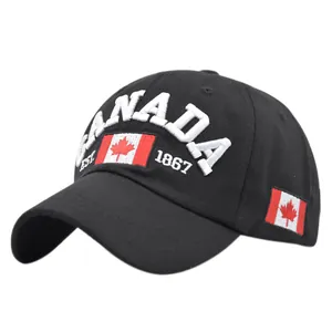 Close-up of Canada flag embroidery and white text on black cotton baseball cap