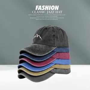 Detail of five washed cotton baseball caps with mountain embroidery and distressed edges