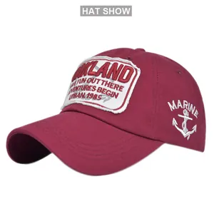 Close-up of embroidered Oakland 1985 patch and anchor marine detail on burgundy cap