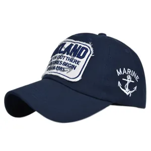 Detailed close-up of navy cotton baseball cap with OAKLAND embroidery and anchor logo