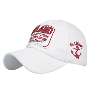 Close-up of white baseball cap with red Oakland Urban embroidery and marine anchor detail