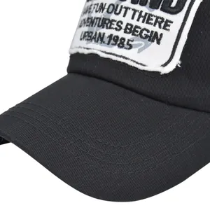 Macro detail of black baseball cap with vintage embroidered patch and reinforced stitching