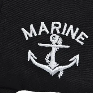 Macro shot of white Marine anchor embroidery on black cotton twill baseball cap fabric