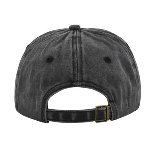 Detail view of washed cotton baseball cap with adjustable brass buckle and strap