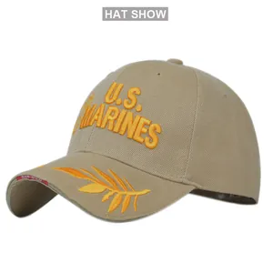 Close-up of yellow 3D embroidery U.S. MARINES text and laurel leaves on a khaki base