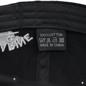 Detail view of cotton baseball cap interior featuring a 100% cotton label and sweatband