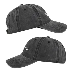 Close-up of wave embroidery and washed vintage texture on charcoal grey cotton baseball cap