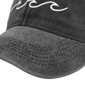 Detail shot of vintage dark grey baseball cap featuring white wave embroidery on front