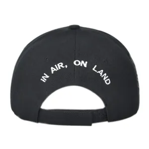 Detail view of adjustable velcro strap and white embroidery on a black baseball cap