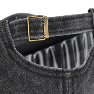 Close-up of a washed cotton baseball cap featuring an adjustable brass metal slider buckle