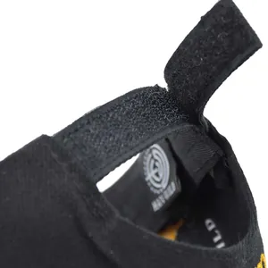 Detail of baby canvas shoe with yellow embroidery and adjustable velcro strap closure