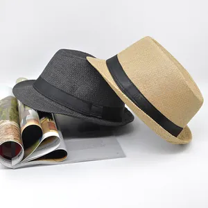 Detail of woven straw fedora hats in dark grey and beige with black ribbon bands