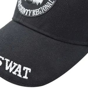 Detailed close-up of tactical black baseball cap with white SWAT embroidery and badge