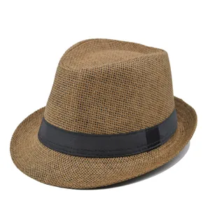 Classic fedora straw hat in light brown with black ribbon, white background front view