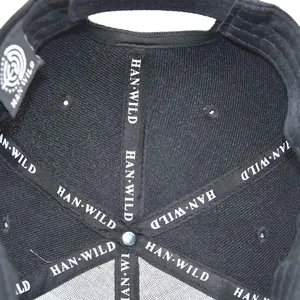 Detail view of the reinforced inner stitching and brand label on a black tactical cap