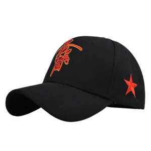 Detail of black cotton baseball cap with red Chinese embroidery and a side star