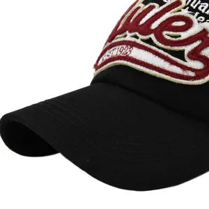 Close-up of 3D embroidery with EST. 1923 text on black cotton baseball cap brim