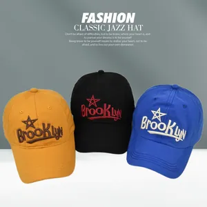 Detailed embroidery of BrookLYN text on yellow, black and blue cotton baseball caps