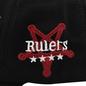 Close-up of 3D Rulers embroidery with red pentagram on black cotton baseball cap