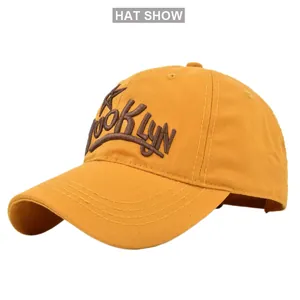 Close-up of 3D Brooklyn embroidery and reinforced stitching on yellow baseball cap