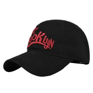 Macro detail of red 3D Brooklyn embroidery on black twill cotton baseball cap fabric