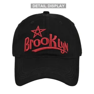 Detail view of red 3D Brooklyn embroidery on a premium black cotton baseball cap