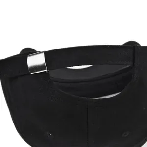 Detail shot of the black cotton baseball cap showing adjustable silver metal buckle strap